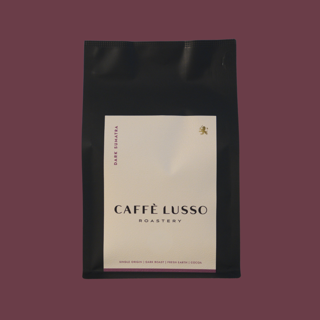 Caffè Lusso coffee bag of Dark Sumatra on a maroon background