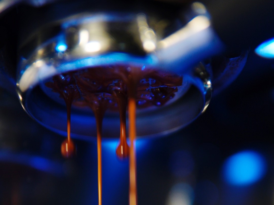 Espresso dripping from a porta filter