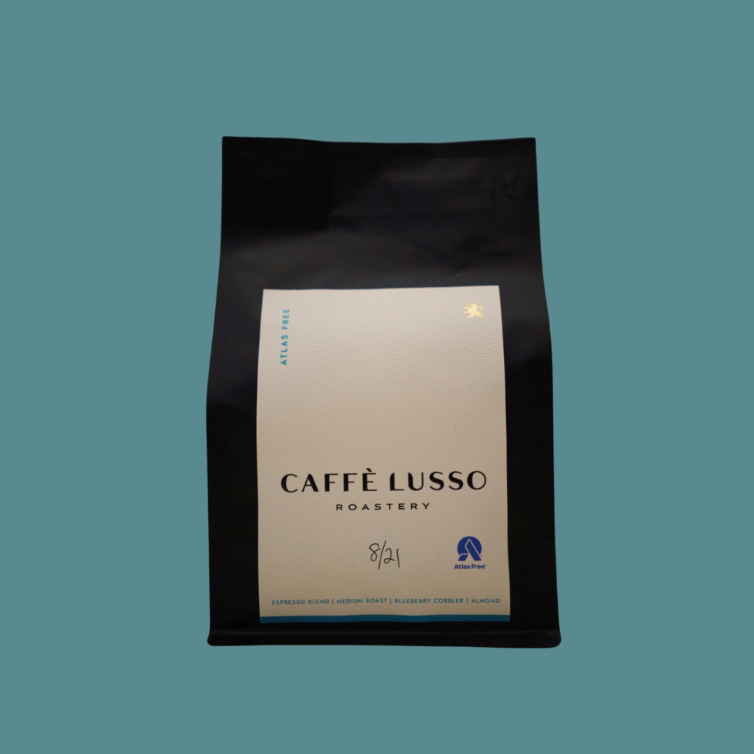 Caffè Lusso coffee bag of Atlas Free Blend on a teal background