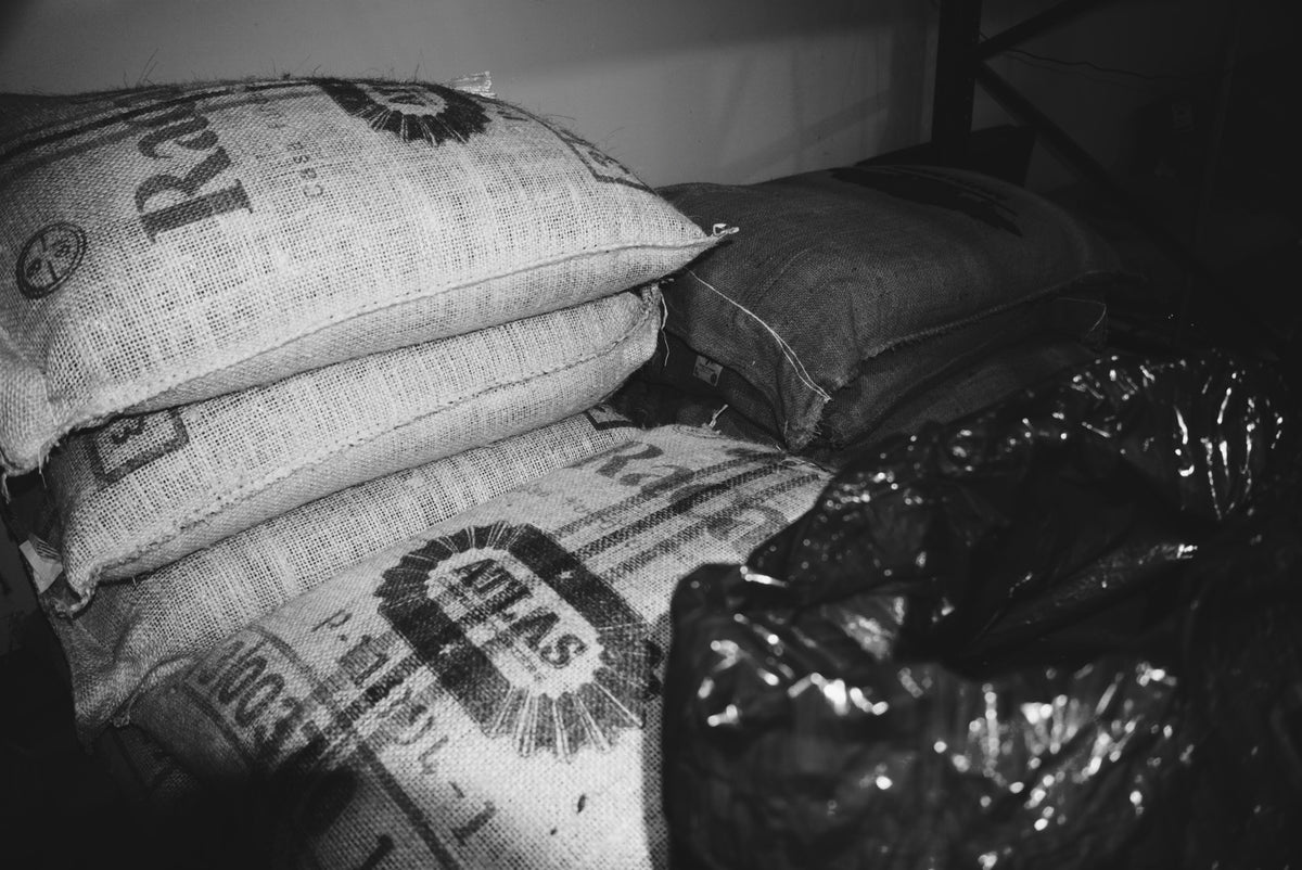black and white picture of sacks of green coffee