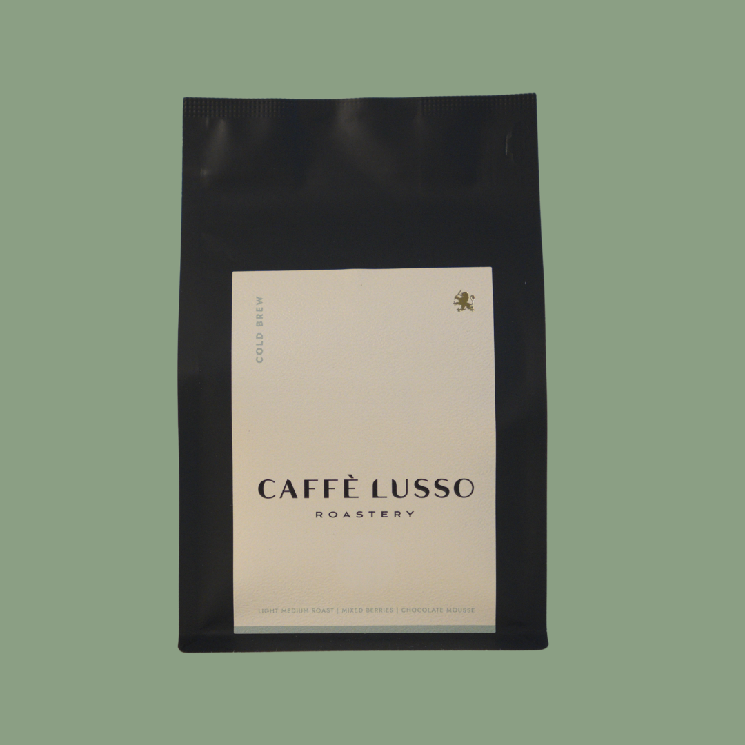 Caffè Lusso coffee bag of Cold Brew on a green background