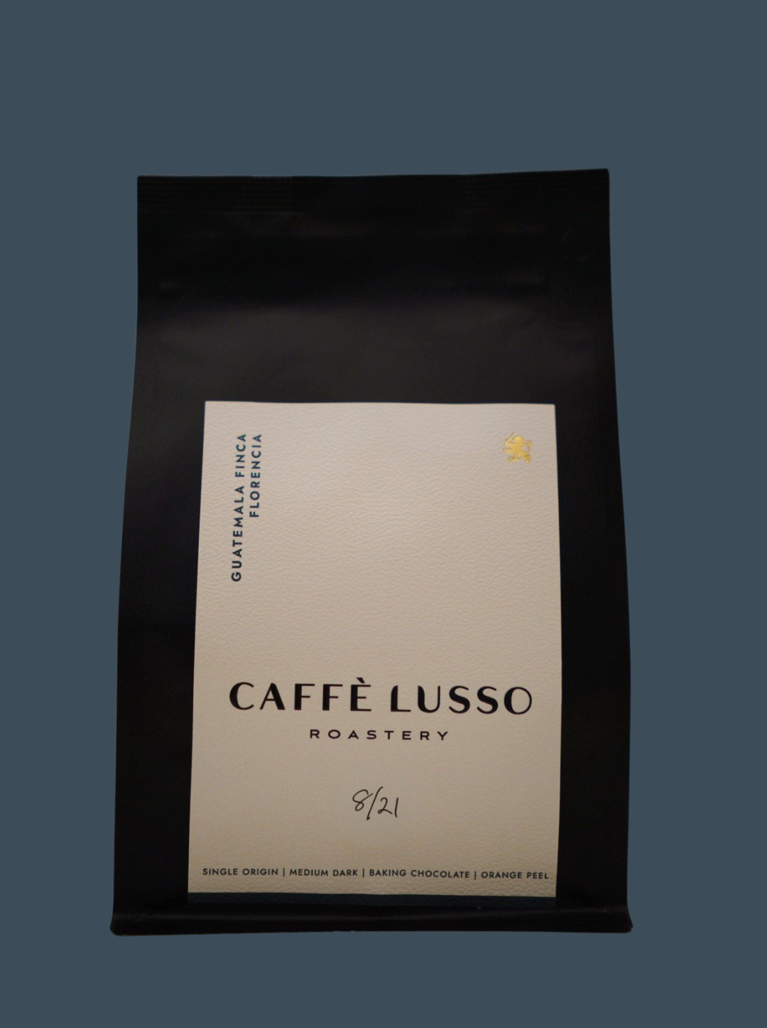 A black coffee bag with a label that includes the brand name 'CAFFÈ LUSSO ROASTERY' and the coffee name 'Guatemala Finca Florencia'.