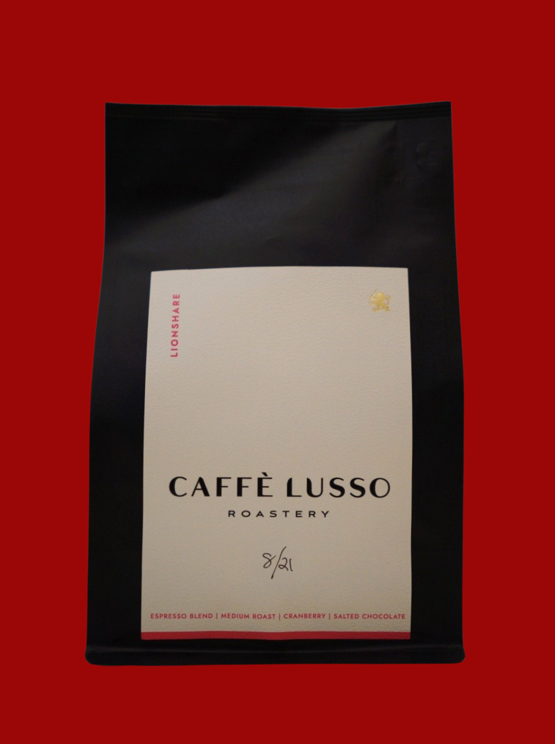 A packaged bag of Lionshare Espresso Blend from Caffè Lusso Roastery, predominantly black with white and red label.