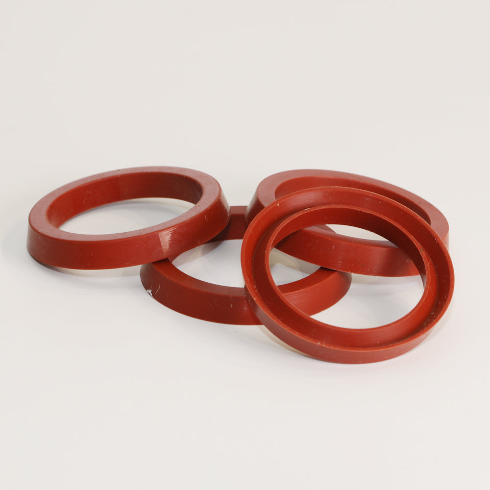 Red silicon piston seals on a white backgorund